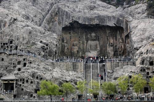 Туристы осматривают буддийские скульптуры Гроты Лунмэнь («Драконовы ворота») недалеко от города Лоян в китайской провинции Хэнань. В этом месте расположено более 2 300 пещер; 110 000 буддистских изображений, более 80 дагоб (буддистских мавзолеев), содержа